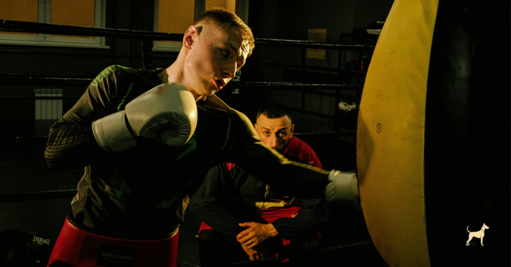 Boxing coach giving calm advice to a focused athlete, symbolising respect and composure